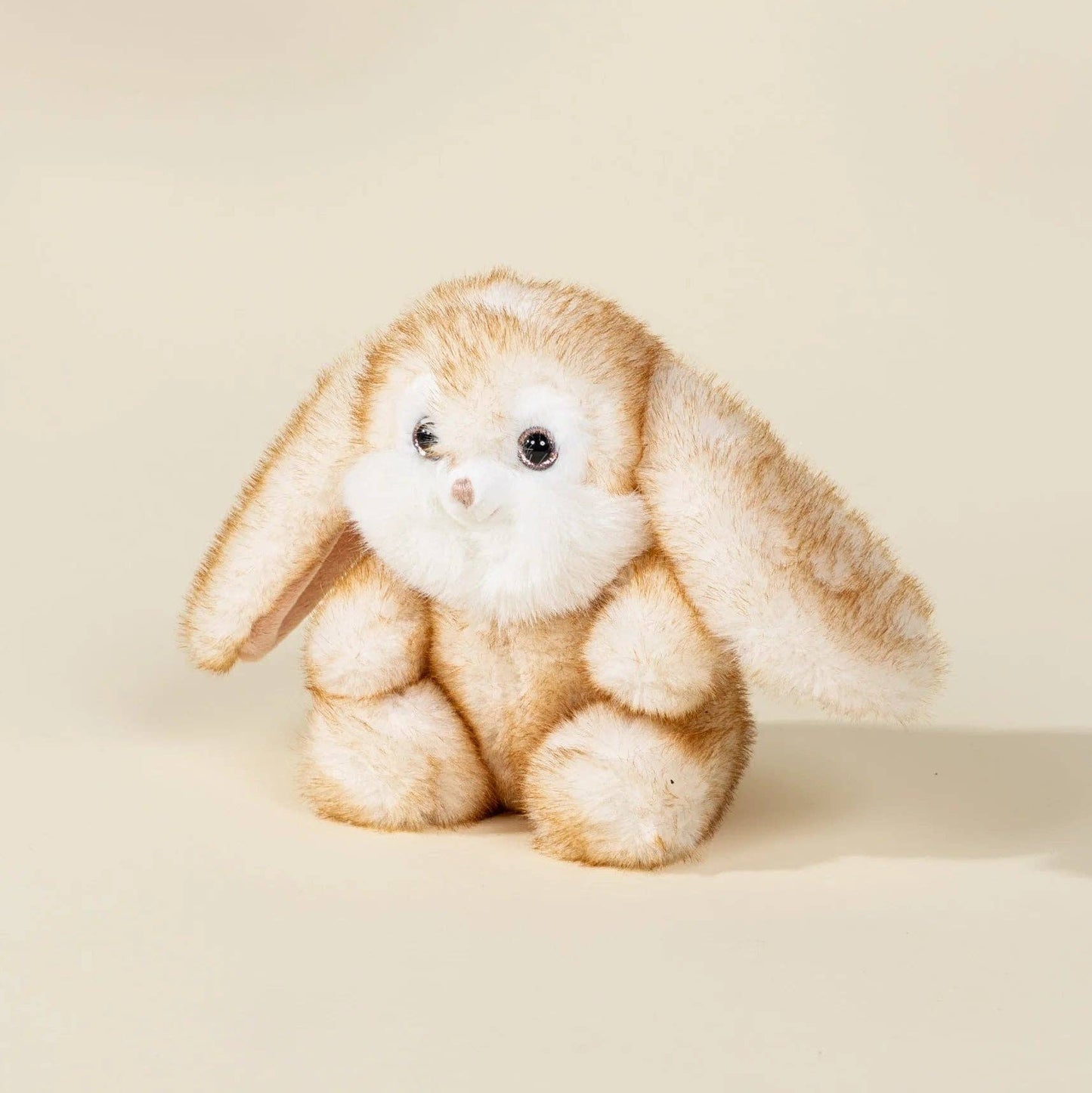 Plush toy rabbit on a beige background