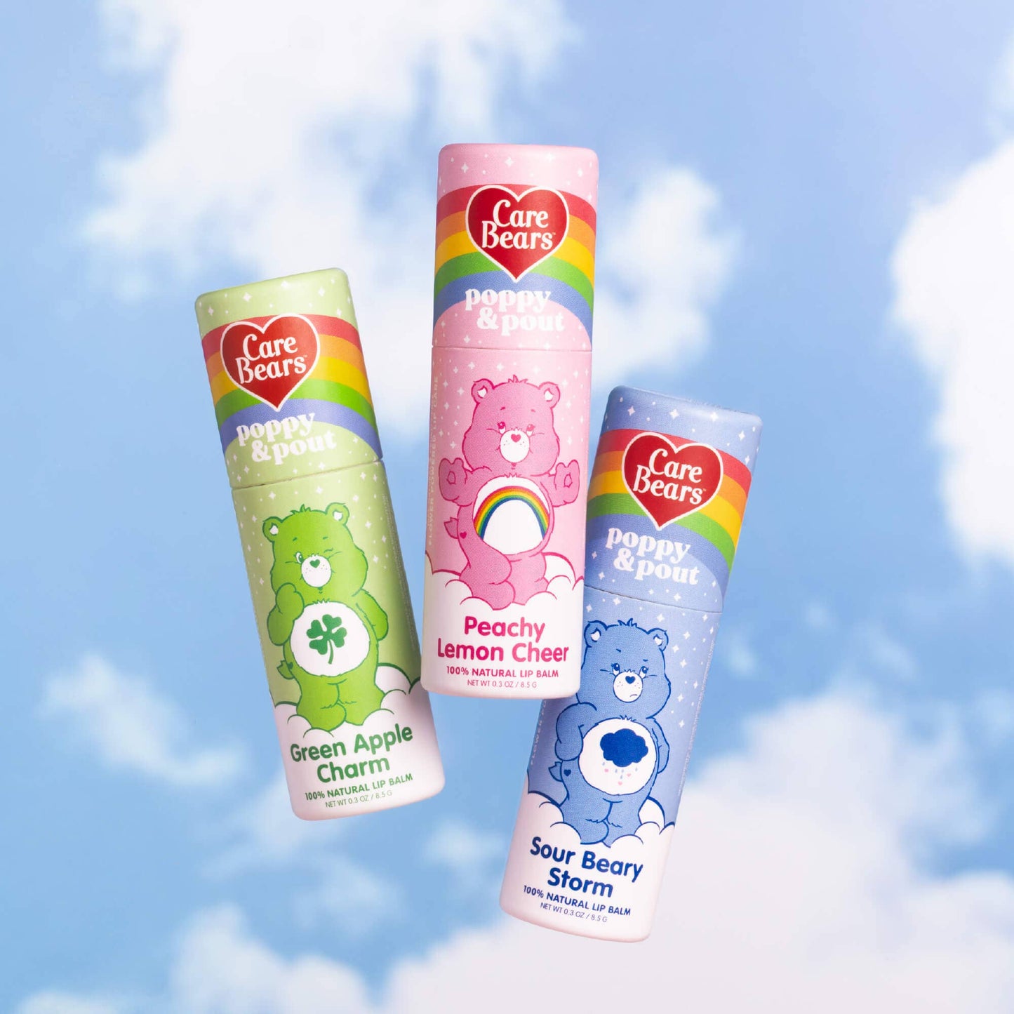 Three Care Bears lip balms with colorful packaging against a blue sky background