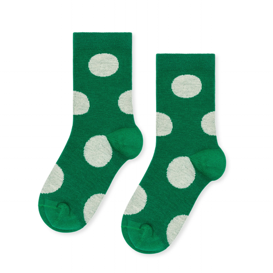 Green socks with white polka dots on a white background